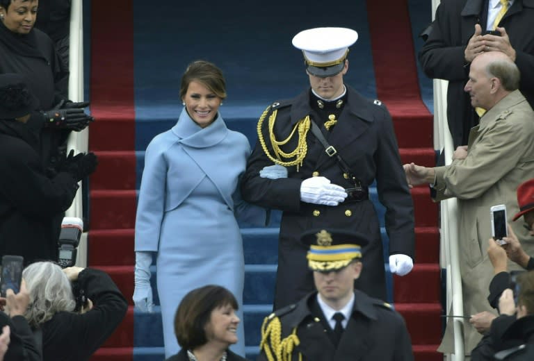 Melania Trump is escorted to her position on the platform at the US Capitol in Washington, DC, on January 20, 2017