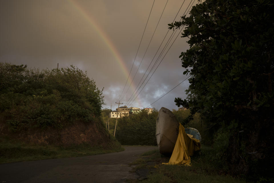 A rainbow is seen in the sky above the village of Belle Garden where the Mauritania boat remained parked for months after it was found drifting near Tobago, in Trinidad and Tobago, Wednesday, Jan. 19, 2022. (AP Photo/Felipe Dana)