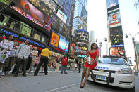 FILE - Serena Williams holds up her U.S. Open championship trophy while posing for photographers in New York's Times Square, Monday, Sept. 8, 2008 in New York. Serena Williams says she is preparing to step away from tennis after winning 23 Grand Slam titles, turning her focus to having another child and her business interests. “I’m turning 41 this month, and something’s got to give,” Williams wrote in an essay released Tuesday, Aug. 9, 2022, by Vogue magazine.(AP Photo/Mary Altaffer, File)