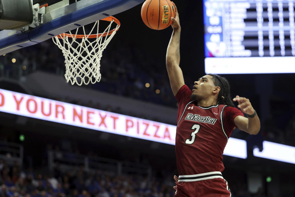 New Mexico State's Christian Cook dunks during the second half of an NCAA college basketball game against Kentucky in Lexington, Ky., Monday, Nov. 6, 2023. (AP Photo/James Crisp)