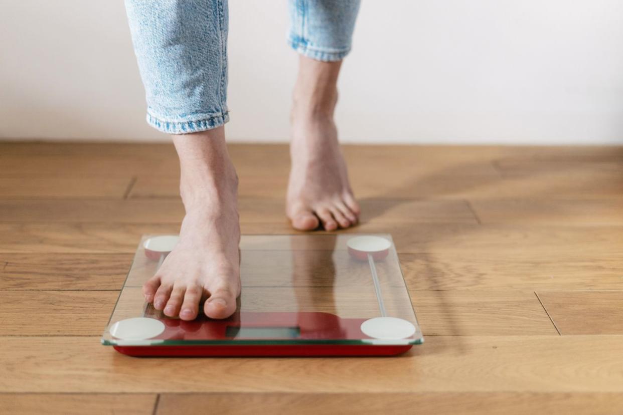 woman step on the floor scales