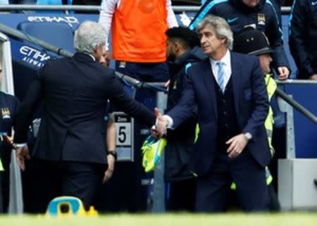 Football Soccer - Manchester City v Stoke City - Barclays Premier League - Etihad Stadium - 23/4/16 Manchester City manager Manuel Pellegrini with Stoke manager Mark Hughes shake hands after the game Action Images via Reuters / Craig Brough Livepic