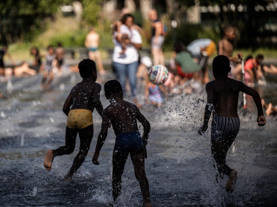 Children play in a fountain.