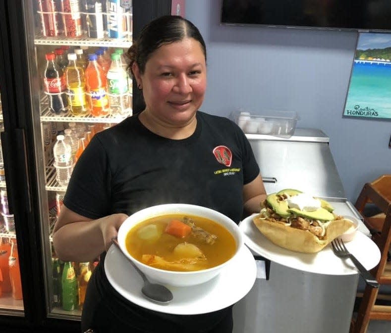 Elsa Lopez delivers meals to diners at J&A Latino Market and Restaurant in Hopewell on May 14, 2024.