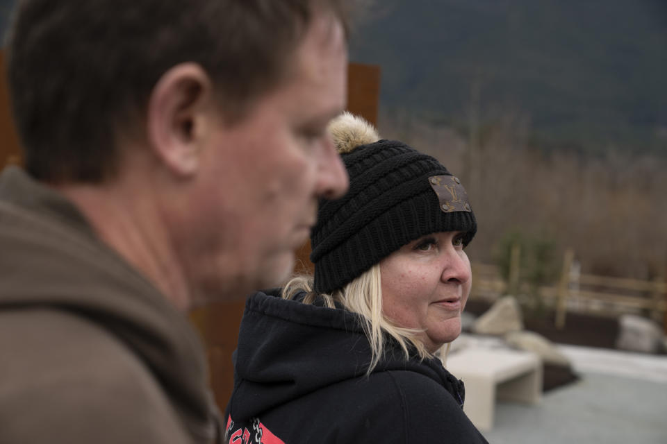 Jessica Pszonka and Dayn Brunner visit the memorial for Oso landslide ahead of the opening on Saturday, Feb. 17, 2024, in Oso, Wash. Brunner lost his sister Summer Raffo in the slide. Pszonka lost her sister Katie, two nephews, and three other family members in the slide. (AP Photo/Jenny Kane)