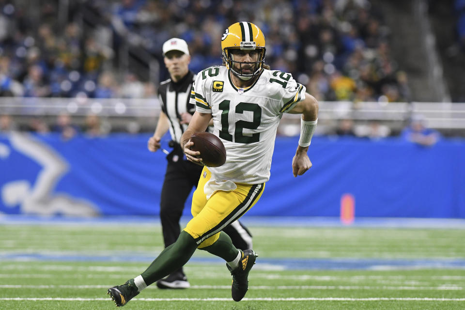 Green Bay Packers quarterback Aaron Rodgers scrambles during the first half of an NFL football game against the Detroit Lions, Sunday, Jan. 9, 2022, in Detroit. (AP Photo/Lon Horwedel)