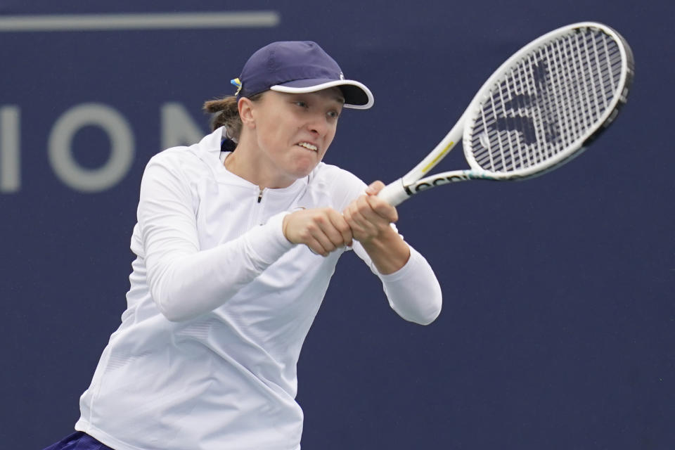 Iga Swiatek of Poland returns to Qinwen Zheng of China at the San Diego Open tennis tournament Thursday, Oct. 13, 2022, in San Diego. (AP Photo/Gregory Bull)