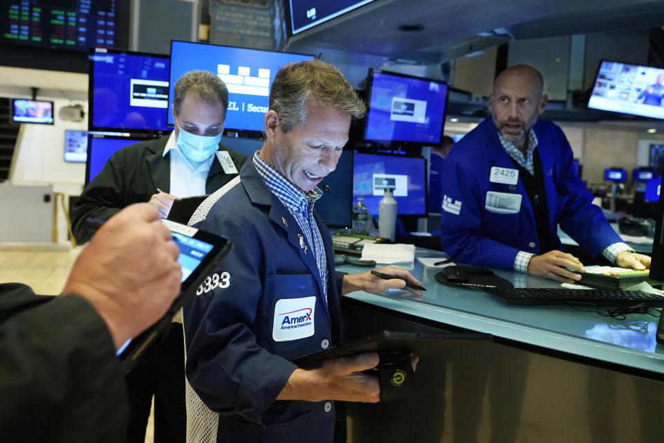 Trader Robert Charmak, center, and specialist Meric Gfeenbaum, right, work on the floor of the New York Stock Exchange, Friday, July 23, 2021. Stocks rose in early trading on Wall Street Friday and put the major indexes on track for a strong finish in a week that opened with a stumble. (AP Photo/Richard Drew)