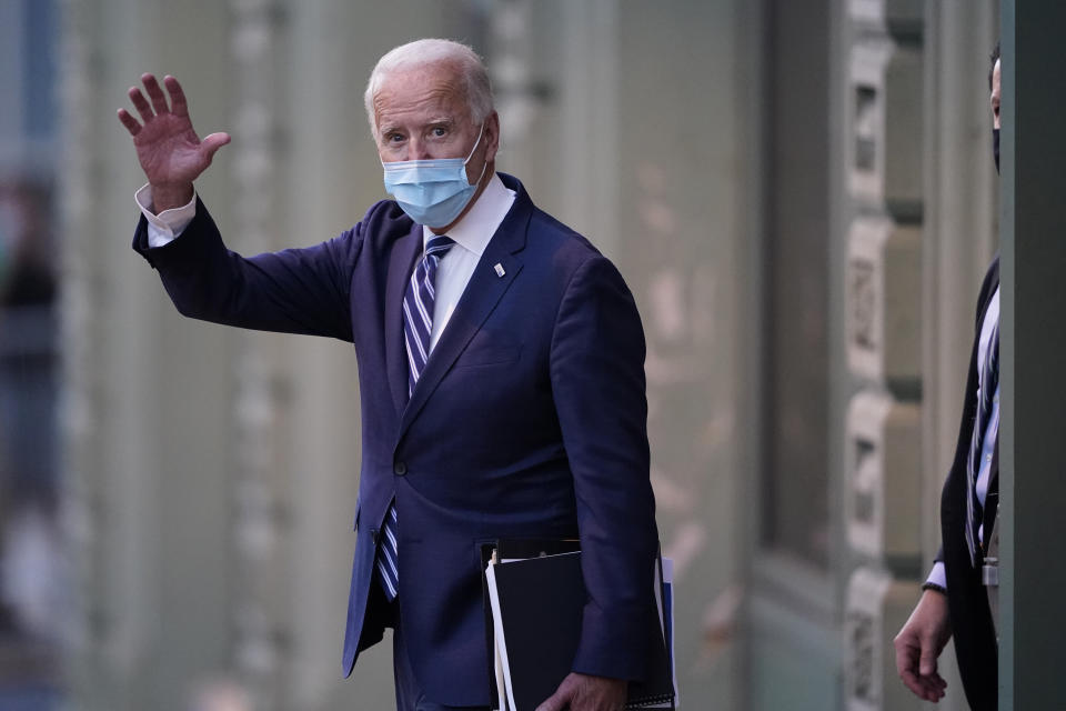 President-elect Joe Biden wavs as he leaves The Queen theater, Tuesday, Nov. 10, 2020, in Wilmington, Del. (AP Photo/Carolyn Kaster)