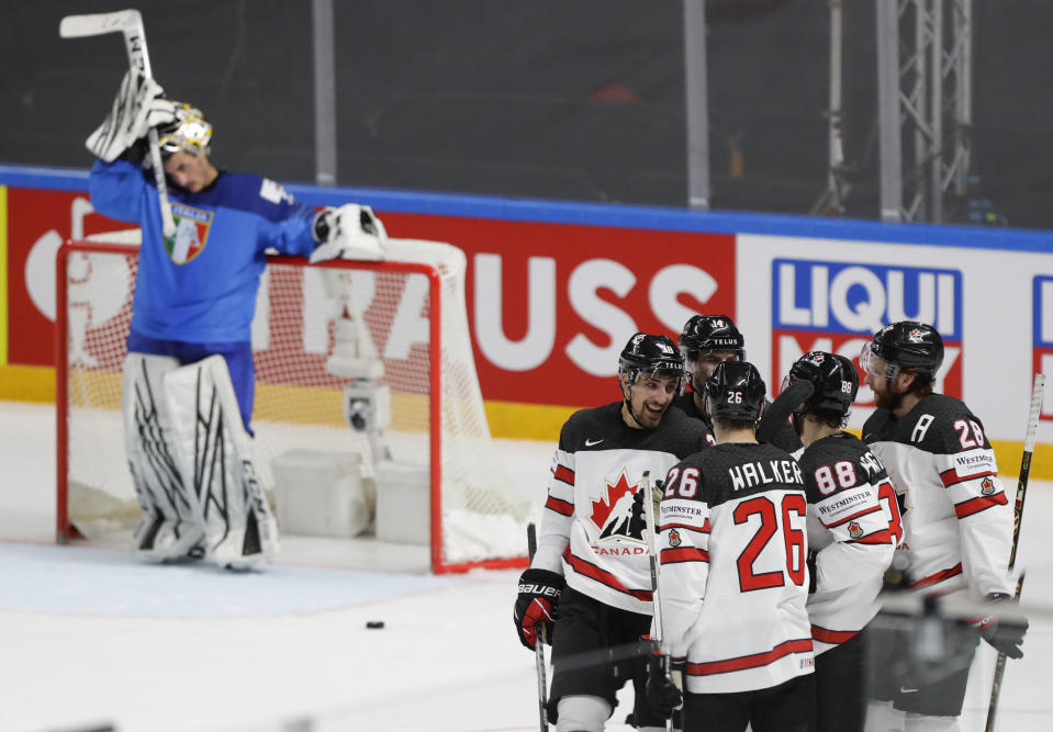 Italy's goaltender Davide Fadani, left, reacts as Canada players celebrate after Canada's Maxime Comtois scored his side's sixth goal during the Ice Hockey World Championship group B match between Italy and Canada at the Arena in Riga, Latvia, Sunday, May 30, 2021. (AP Photo/Sergei Grits)