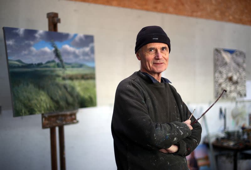 Artist Julian Bell poses for a portrait in his art studio in Lewes