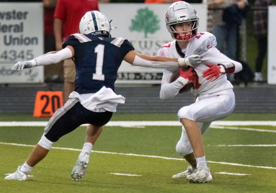 Sandy Valley's Lukas Gilland breaks the grasp of Fairless' Cameron Carl on his way to score a touchdown during the second quarter of this year's season opener.