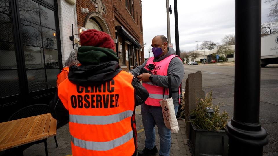 Nox, a clinic escort with Metropolitan Medical Associates in Englewood, NJ is shown helping put a body camera on one of the clinic observers on Saturday, March 25, 2023. Nox has been body-checked and shoved by anti-abortion protesters.