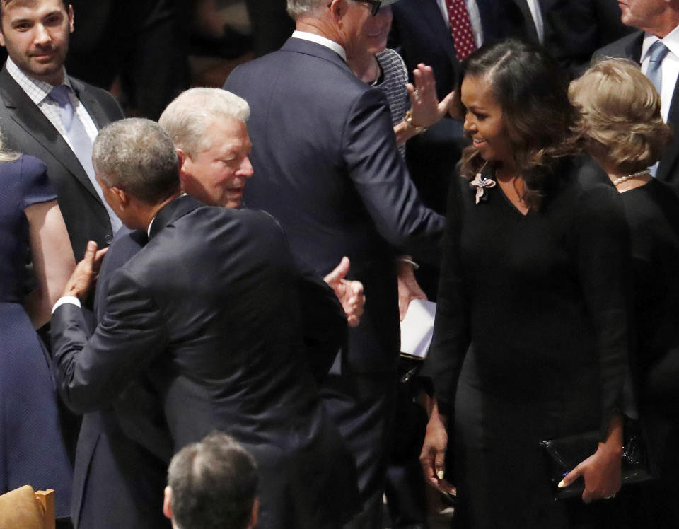 Former President Barack Obama hugs former vice president Al Gore as former first lady Michelle Obama watches before the memorial services for Sen. John McCain, R-Ariz., at Washington National Cathedral in Washington, Saturday, Sept. 1, 2018. McCain died Aug. 25, from brain cancer at age 81. (AP Photo/Pablo Martinez Monsivais)