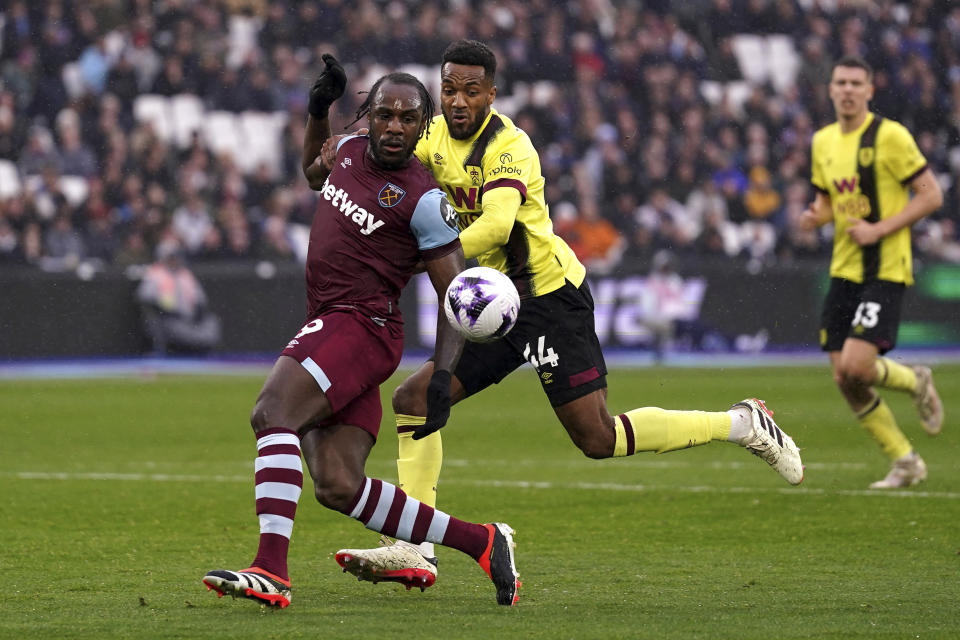 West Ham United's Michail Antonio, left, and Burnley's Hannes Delcroix battle for the ball during the English Premier League soccer match between Burnley FC and West Ham United at the London Stadium in London, Sunday March 10, 2024. (Bradley Collyer/PA via AP)