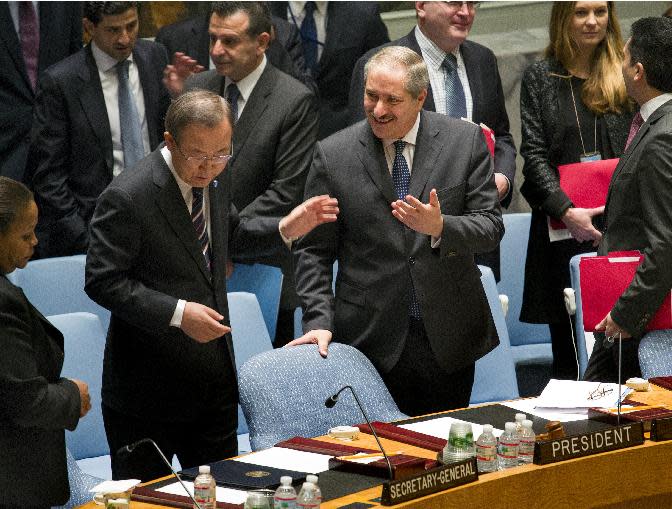 Jordanian Foreign Minister and President of the United Nations Security Council Nasser Judeh, right, has a conversation with U.N. Secretary-General Ban Ki-moon as the Security Council meeting began at U.N. headquarters, Monday, Jan. 20, 2014. Ban says "intensive and urgent discussions are under way" around his invitation for Iran to join this week's peace talks on Syria. (AP Photo/Craig Ruttle)