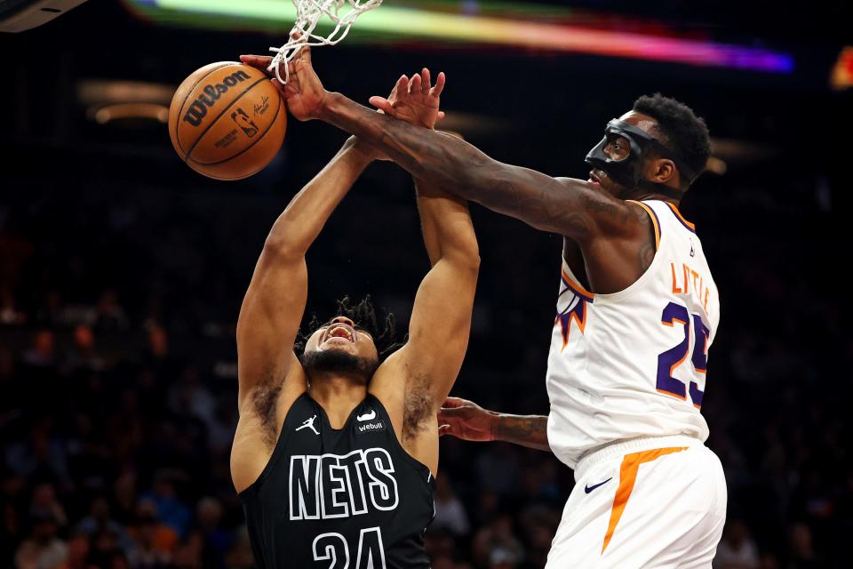Phoenix Suns forward Nassir Little (25) blocks the shot of Brooklyn Nets guard Cam Thomas (24) during the second quarter at Footprint Center in Phoenix on Dec. 13, 2023.