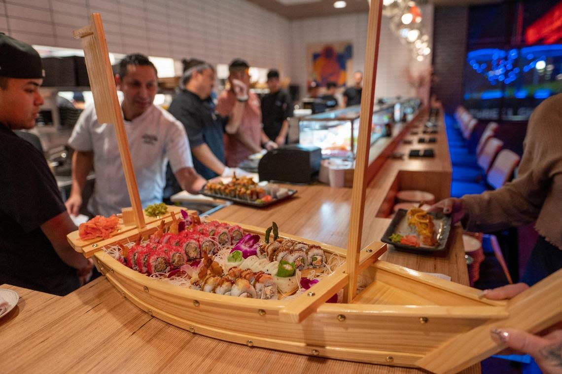 Various sushi rolls are served on a wooden sailboat platter at Blue Sushi Sake Grill.