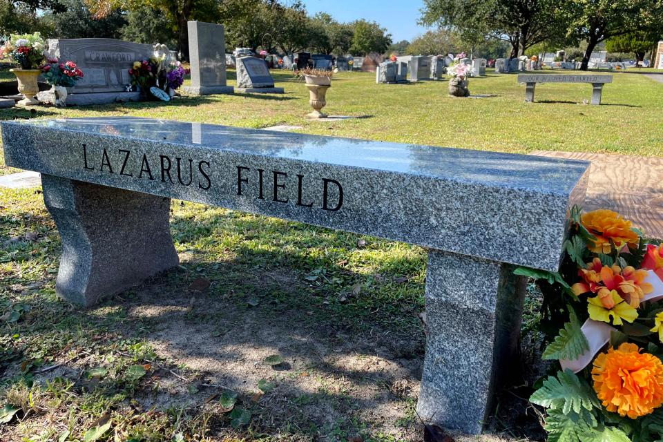 Two stone benches book-end Lazarus Field at the Beal Memorial Cemetery in Fort Walton Beach. Community leaders, clergy and members of the public gathered Wednesday to honor those people who have died in Okaloosa County without the means or family members to provide for a funeral service and burial.