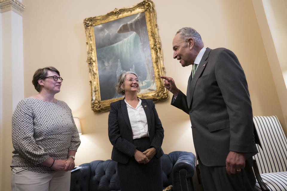 Senate Majority Leader Chuck Schumer, D-N.Y., right, welcomes Paivi Nevala, minister counselor of the Finnish Embassy, left, and Karin Olofsdotter, Sweden's ambassador to the U.S., center, just before the Senate vote to ratify NATO membership for the two nations in response to Russia's invasion of Ukraine, at the Capitol in Washington, Wednesday, Aug. 3, 2022. (AP Photo/J. Scott Applewhite)