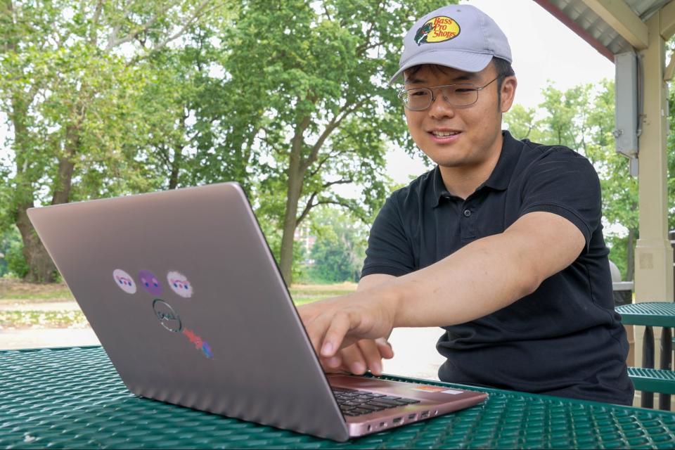 Liu He looks through his spreadsheets that he uses to record past catches and predict future ones Thursday, June 15, 2023, at Tapawingo Park on the Wabash River in West Lafayette.