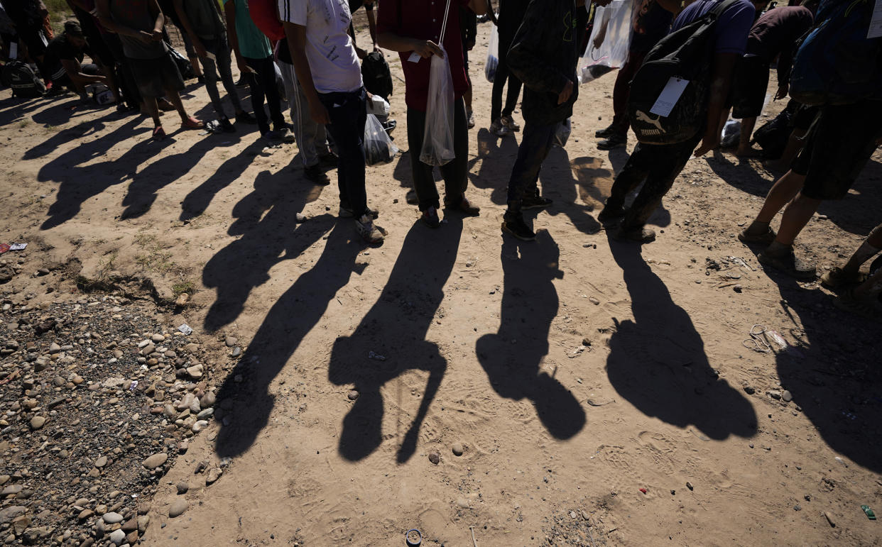 FILE - Migrants wait to be processed by the U.S. Customs and Border Patrol after they crossed the Rio Grande and entered the U.S. from Mexico, Oct. 19, 2023, in Eagle Pass, Texas. The mayor of Eagle Pass, a Texas border city that's at the center of Republican Gov. Greg Abbott's aggressive measures to curb migrant crossings, accused the state Thursday, Jan. 11, 2024, of a new escalation, saying state troopers closed a large public park along the Rio Grande without asking permission. (AP Photo/Eric Gay, File)