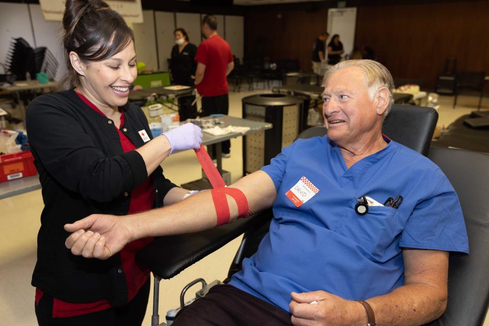 Blood donor waits out the process of donating blood to the American Red Cross. There's a 25% blood and platelet supply shortage as of August because of natural disasters, climate change, school activities and travel schedules.