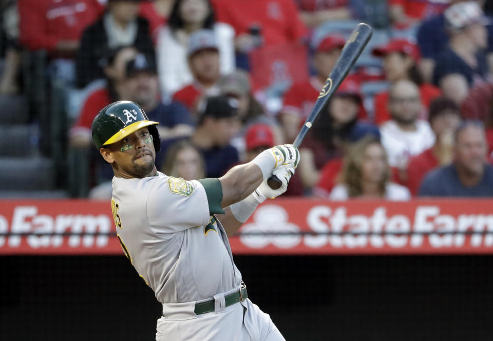 Oakland Athletics' Khris Davis follows through on his two-run home run against the Los Angeles Angels during the first inning of a baseball game Saturday, Sept. 29, 2018, in Anaheim, Calif. (AP Photo/Marcio Jose Sanchez)