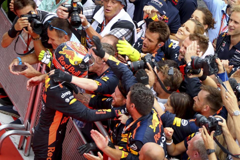 Dutch Formula One driver Max Verstappen of Red Bull Racing celebrates with team members after winning the Malaysian Formula One Grand Prix