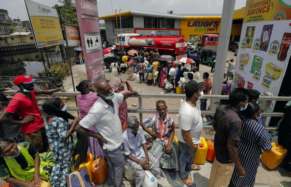 People stand in a long queue to buy kerosene oil for kerosene cookers amid a shortage of domestic gas due to country's economic crisis, at a fuel station in Colombo, Sri Lanka March 21, 2022. REUTERS/Dinuka Liyanawatte