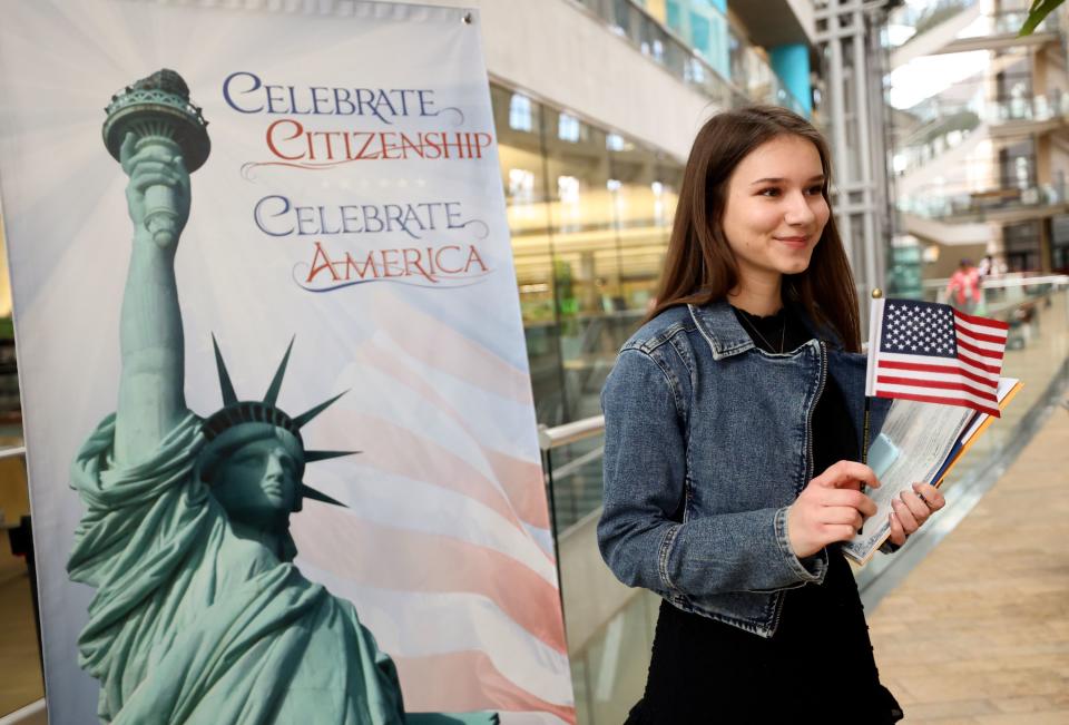 Kira Kecskes, from Hungary, poses for a photograph that her mother is taking after becoming a citizen at a naturalization ceremony at the Salt Lake City Public Library in Salt Lake City on Wednesday, Feb. 14, 2024. | Kristin Murphy, Deseret News