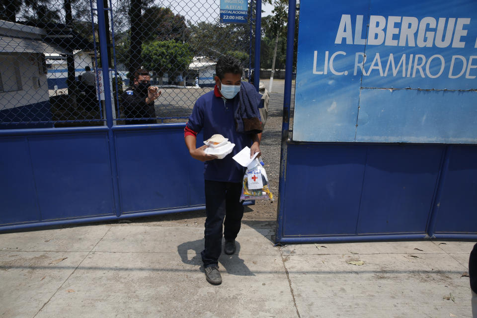 A deported man leaves the site where Guatemalans returned from the U.S. are being held in Guatemala City, Friday, April 17, 2020. Recently deported Guatemalans were placed in a athletic dorm facility to wait for the results of their tests for the new coronavirus. (AP Photo/Moises Castillo)