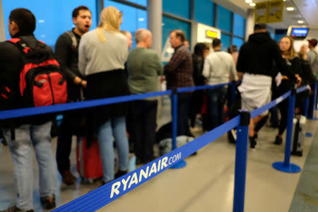 Passengers prepare to board a Ryanair flight at Stansted Airport, Britain, October 12, 2017. Picture taken October 12, 2017 REUTERS/Hannah McKay