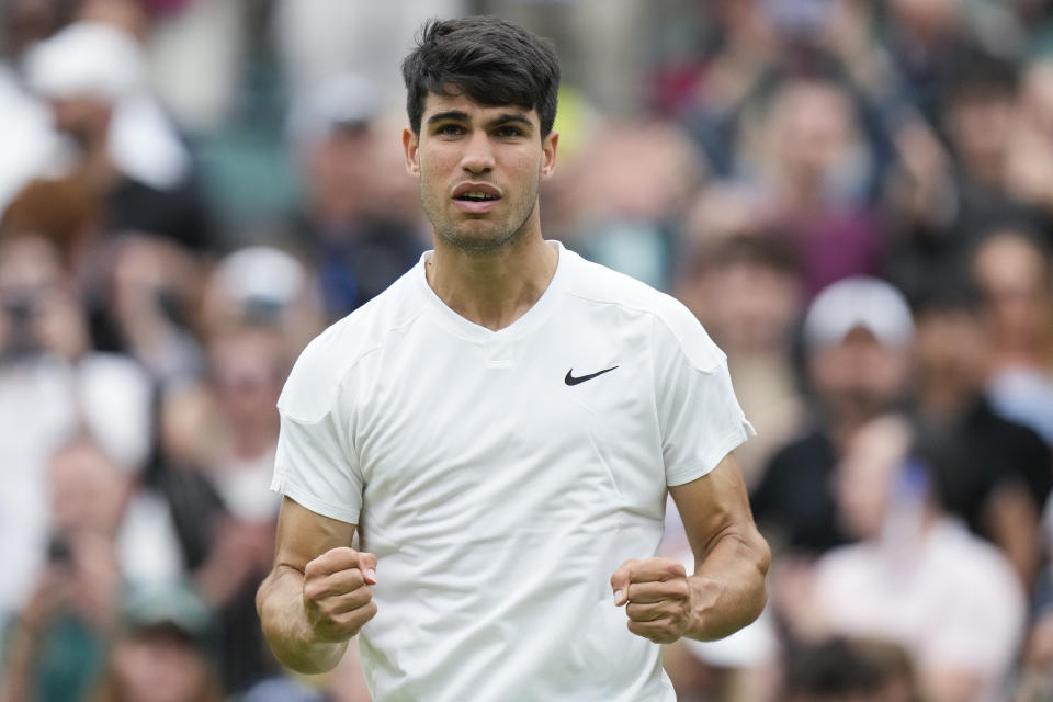 Carlos Alcaraz of Spain celebrates after defeating Aleksandar Vukic of Australia during their match on day three at the Wimbledon tennis championships in London, Wednesday, July 3, 2024. (AP Photo/Mosa'ab Elshamy)