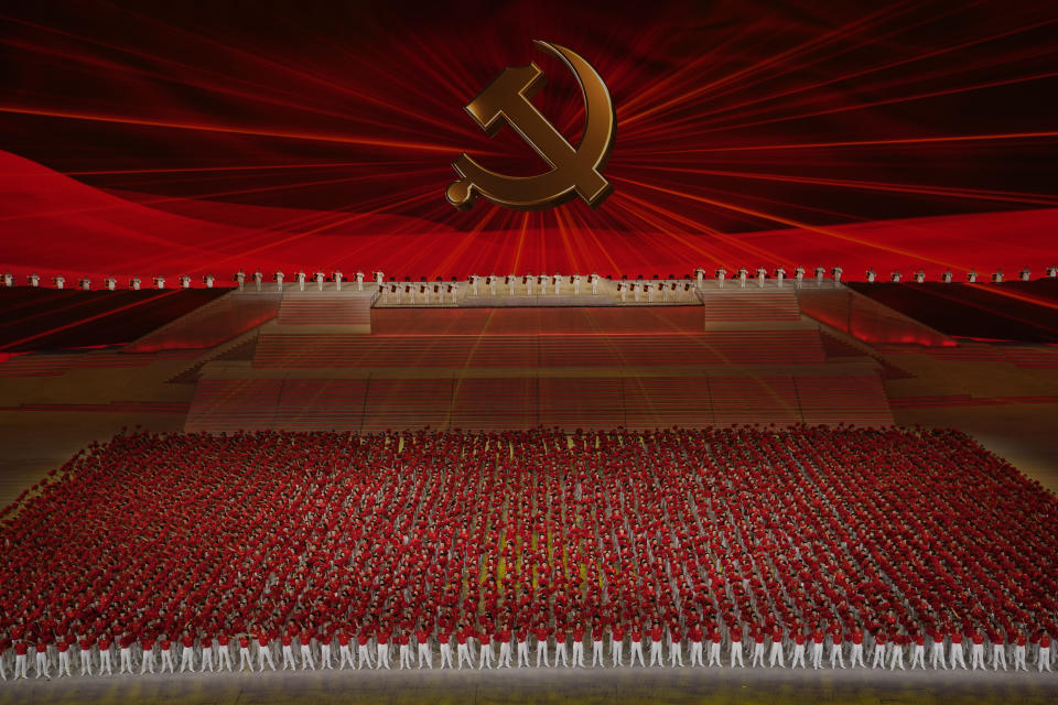 Performers line up , in front of the Communist Party emblem at a gala show ahead of the 100th anniversary of the founding of the Chinese Communist Party in Beijing on Monday, June 28, 2021. China is marking the centenary of its ruling Communist Party this week by heralding what it says is its growing influence abroad, along with success in battling corruption at home. (AP Photo/Ng Han Guan)