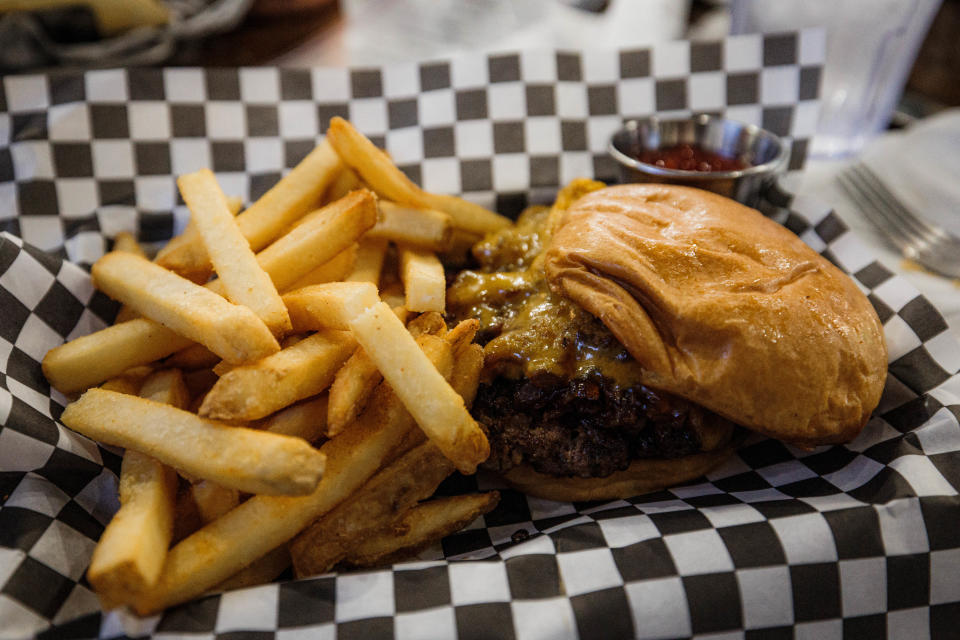 Remi's Arcade & Bistro's Classic Bacon Jam Burger features 1/3lb beef patty, bacon jam and cheddar cheese.