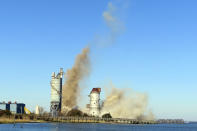 The smokestack at the former B.L. England power plant in Upper Township, N.J., is toppled during a control demolition, Thursday, Oct. 26, 2023. The site will be redeveloped as a mixed use residential and commercial project, and a nearby electrical substation will be used to connect New Jersey's soon-to-come offshore wind farms with the electrical grid. (AP Photo/Wayne Parry)