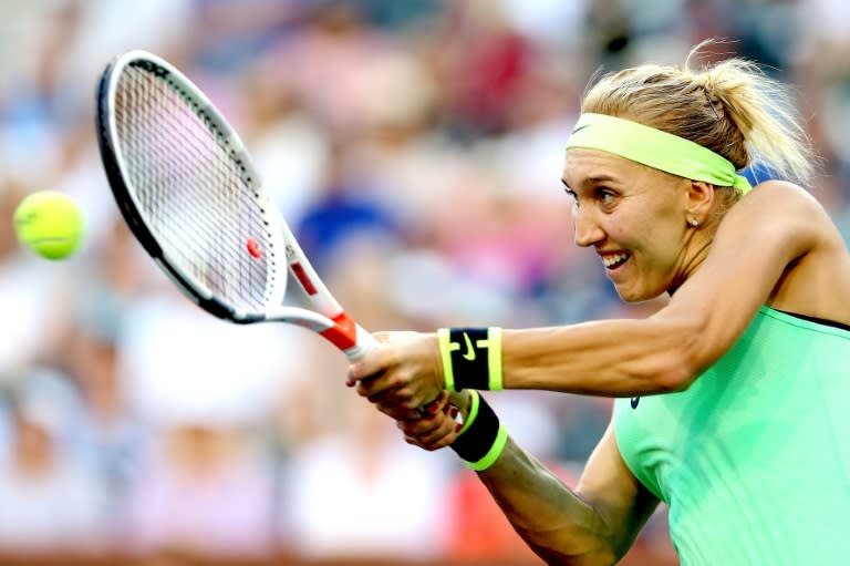 Elena Vesnina of Russia returns a shot to Venus Williams during their quarter-final match at Indian Wells