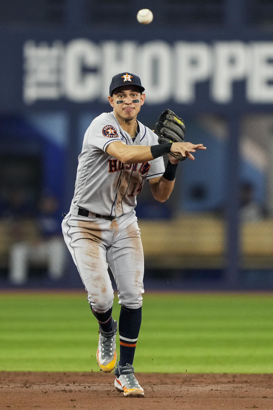 Houston Astros shortstop Mauricio Dubon (14) makes the throw to first base to force out Toronto Blue Jays right fielder George Springer (4) during the third inning of a baseball game in Toronto on Wednesday, June 7, 2023. (Andrew Lahodynskyj/The Canadian Press via AP)