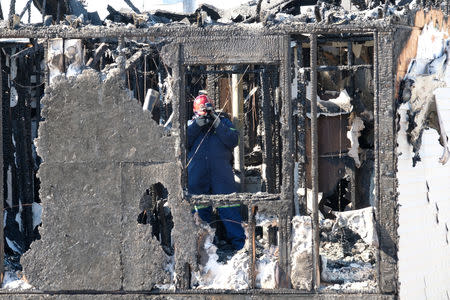 A fire investigator is seen at the house where seven children died from a fatal structure fire in the community of Spryfield in Halifax, Nova Scotia, Canada, on February 20, 2019. REUTERS/Ted Pritchard