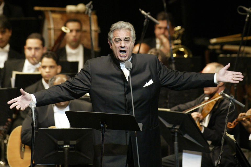 FILE - In this Jan. 22, 2004, file photo, Placido Domingo sings during his performance at the National Theater in Santiago, Dominican Republic. Domingo is scheduled to appear onstage at the Salzburg Festival Aug. 25, 2019, to perform for the first time since multiple women have accused the opera legend of sexual harassment in allegations brought to light by The Associated Press. (AP Photo/Miguel Gomez, File)