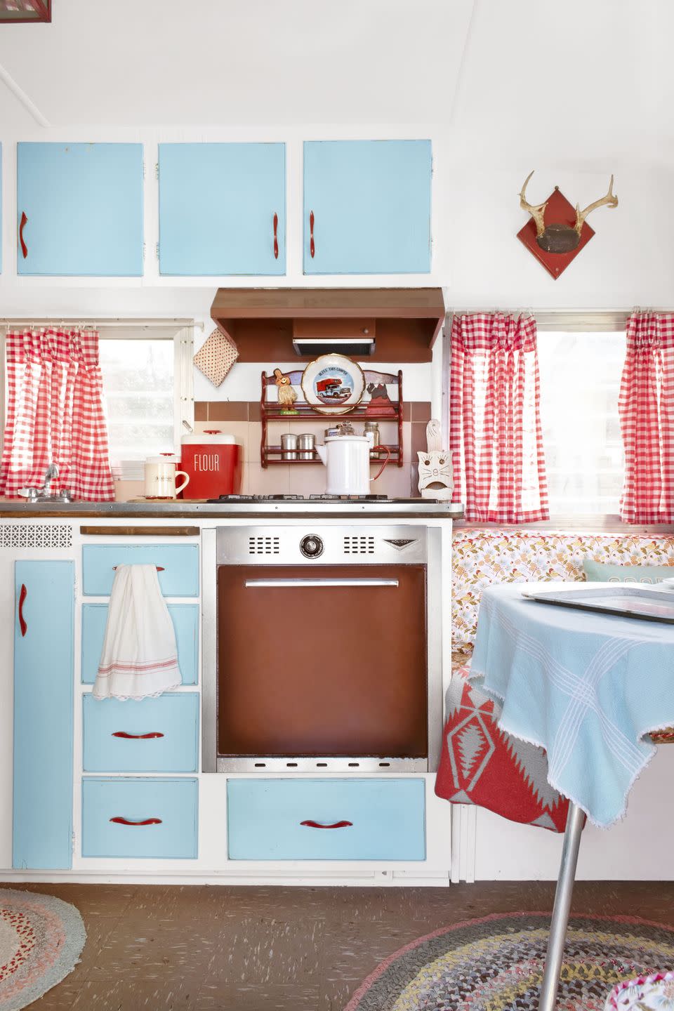 <p>A small camper kitchen goes from blah to easy-breezy thanks to a little spray paint on the cabinets. Design House at Luckett's Store co-owner Amy Whyte spiffed up the kitchen with gingham, red pulls, and a can or two of <a href="https://go.redirectingat.com?id=74968X1596630&url=https%3A%2F%2Fwww.homedepot.com%2Fp%2FRust-Oleum-Stops-Rust-12-oz-Protective-Enamel-Gloss-Light-Turquoise-Spray-Paint-284678%2F205585924&sref=https%3A%2F%2Fwww.popularmechanics.com%2Fhome%2Fg37190959%2Fpaint-colors-small-rooms%2F" rel="nofollow noopener" target="_blank" data-ylk="slk:Rust-Oleum Turquoise;elm:context_link;itc:0;sec:content-canvas" class="link ">Rust-Oleum Turquoise</a>. <br></p>