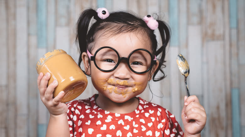 Girl eating peanut butter