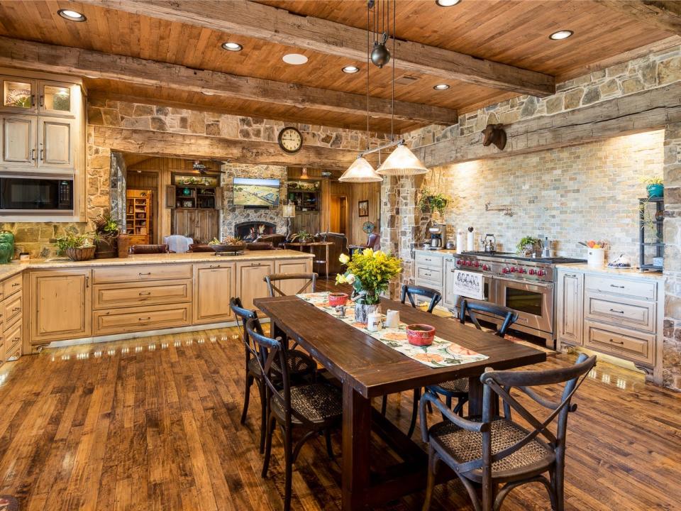 Terry Bradshaw's kitchen is full of dark woods and stone walls.