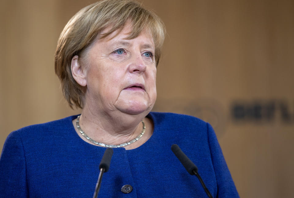 BERLIN, GERMANY - NOVEMBER 22: Acting German Chancellor Angela Merkel gives a speech as she visits the TUMO Learning Center on November 22, 2021 in Berlin, Germany. TUMO is a new learning center for young people that offers free courses in fields including robotics, computer programming, animation, photography, music production and graphic design. Merkel will be stepping down as chancellor once the Bundestag, Germany's parliament, elects her successor following federal parliamentary elections held last September. The German Social Democrats (SPD), the Greens Party and the German Free Democrats (FDP) are currently in negotiations for creating a new government coalition.  (Photo by Andreas Gora-Pool/Getty Images)