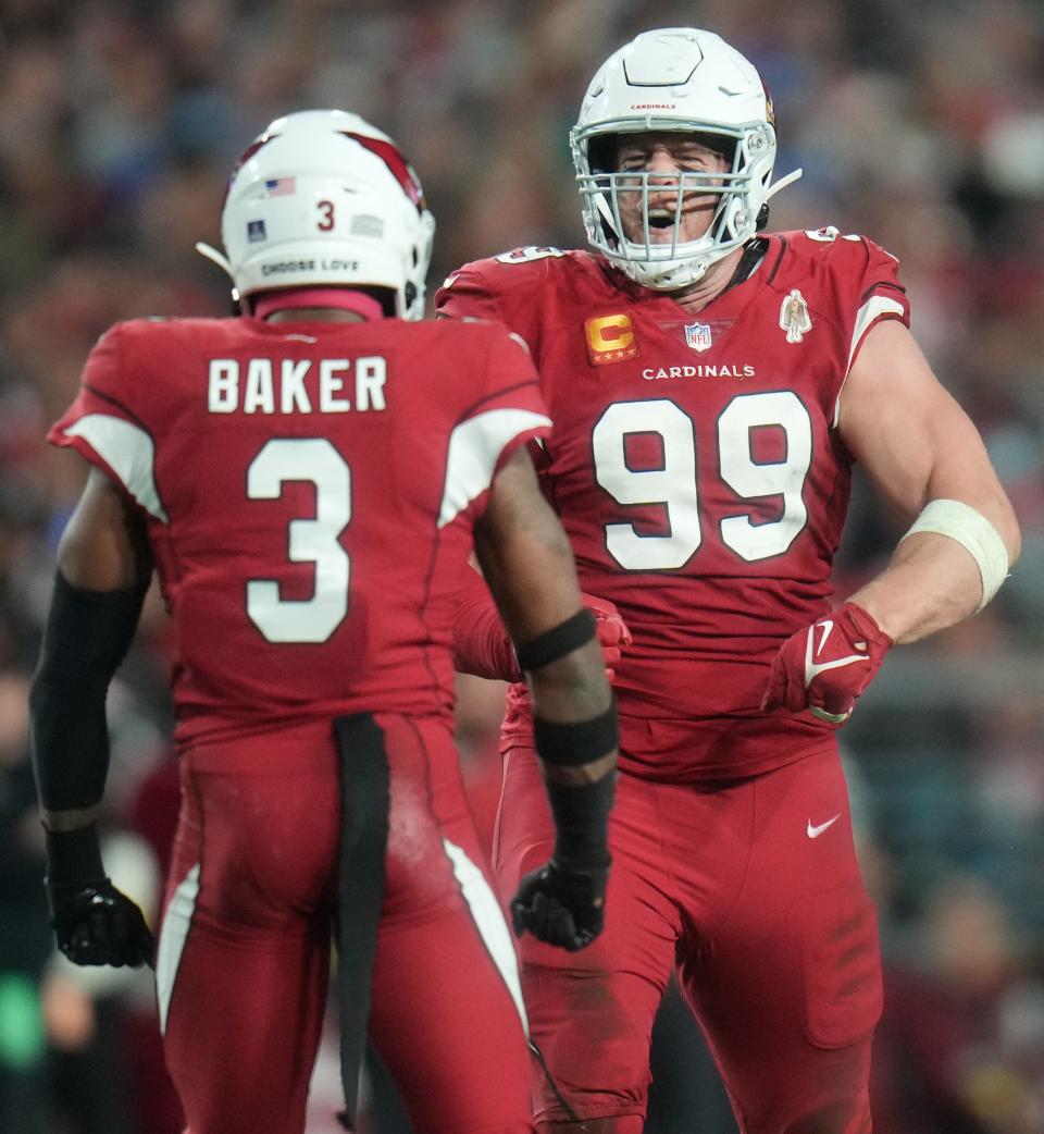 Dec 25, 2022; Glendale, Arizona, USA; Arizona Cardinals defensive lineman J.J. Watt (9) celebrates his tackle with teammate Budda Baker (3) against the Tampa Bay Buccaneers at State Farm Stadium.