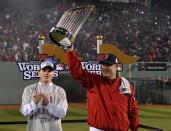 Oct 30, 2013; Boston, MA, USA; Boston Red Sox manager John Farrell hoists the World Series championship trophy after game six of the MLB baseball World Series against the St. Louis Cardinals at Fenway Park. The Red Sox won 6-1 to win the series four games to two. Mandatory Credit: Robert Deutsch-USA TODAY Sports