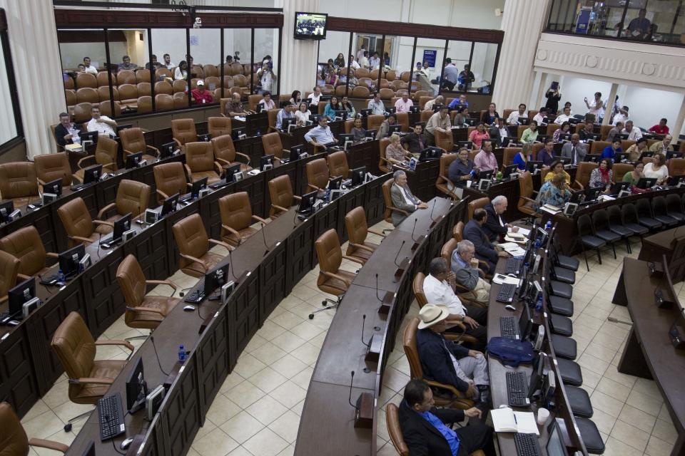 Seats left vacant in the Nicaraguan National Assembly after opposition legislators walked out of the building in protest to an amendment that includes eliminating presidential term limits in Managua, Nicaragua, Tuesday, Jan. 28, 2014. Lawmakers have approved constitutional changes that would allow President Daniel Ortega to be re-elected indefinitely, a move that his critics say is designed to keep the Sandinista leader in power for life. (AP Photo/Esteban Felix)