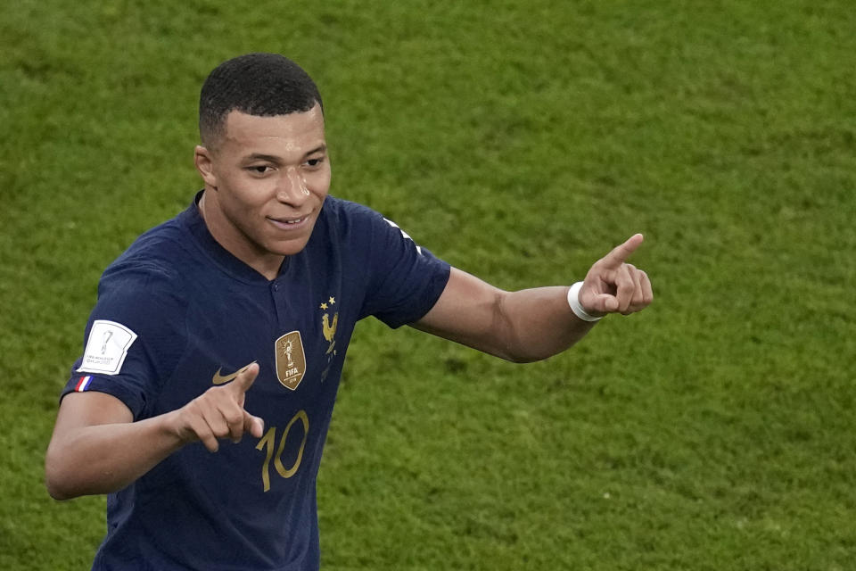 France's Kylian Mbappe celebrates after scoring his side's second goal during the World Cup round of 16 soccer match between France and Poland, at the Al Thumama Stadium in Doha, Qatar, Sunday, Dec. 4, 2022. (AP Photo/Christophe Ena)