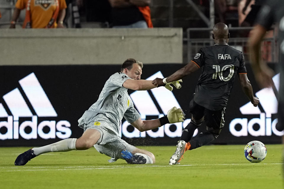 Houston Dynamo's Fafà Picault (10) is fouled by Nashville SC goalkeeper Joe Willis in the penalty box during the second half of a soccer match Saturday, May 14, 2022, in Houston. The Dynamo scored on the penalty kick. (AP Photo/David J. Phillip)